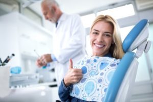 a patient giving a thumbs up before their tooth extraction